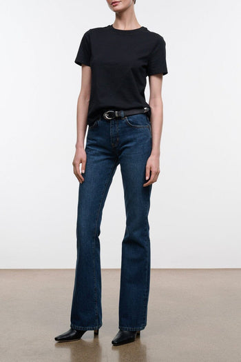 Dark blue flare jeans with belt loops, button fly, and wide straight legs