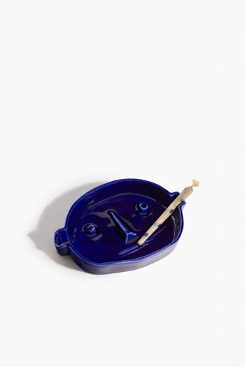Henry Blue ceramic ashtray with face-like relief and cigar-rest slot, blue tray