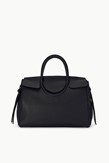 Maude carryall bag in black with curved top handle and side tassel accents.