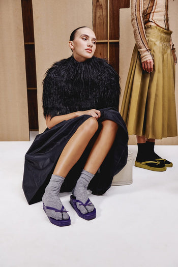 Split-toe tabi socks in dark gray and black, showing separated toe design
