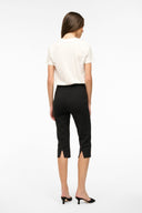 Black cropped pants, back view; slim straight fit