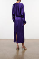 Purple silk midi dress with low back and long sleeves; front slit at hem