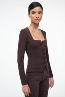 Brown square-neck top with long sleeves, front buttons, and patch pocket detail
