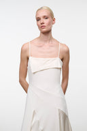 Ivory maxi dress with spaghetti straps, draped bodice, and asymmetrical waist overlay