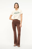 Dark brown flare-leg pants shown in full length with smooth, matte finish