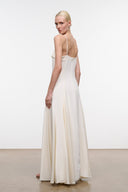 Ivory maxi dress back view with thin straps and flowing skirt with vertical drape