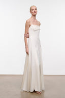 Ivory maxi dress with thin straps and asymmetrical neckline; side drape folds