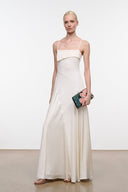 Ivory maxi dress with spaghetti straps, fitted bodice, and smooth draped skirt
