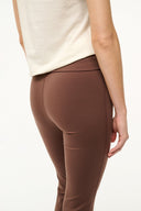 Dark brown fitted pants with side curve seam and smooth stretch finish