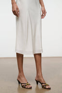 Crisscross strap mule sandals with low heels, worn with a light midi dress