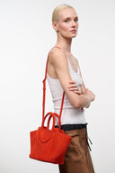 Maude mini tote bag in tangelo orange, front view with rounded handles and short strap.