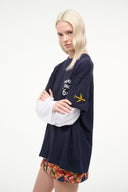 Navy graphic T-shirt with sleeve logo and 'Member Since 66' front; colorful hem panel