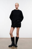 Black knee-high boots with rounded toe and low-profile sole