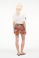 Back view of printed mini skirt with travel-map pattern and elastic waistband