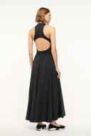Black sleeveless maxi dress with open back and pleated full skirt, high neck