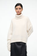 Ivory cashmere sweater with turtleneck, long sleeves, ribbed hem and cuffs