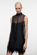 Black sleeveless mini dress with high neck sheer bodice and feather fringe