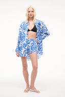 White paddle shorts with blue graphic print, elastic waistband, relaxed front view