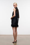 Black sleeveless mini dress side view with high neck and feather fringe hem