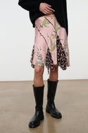 Silk skirt in dusty pink with multicolor botanical print and uneven layered hem