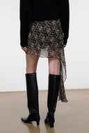 SEPHIE asymmetrical skirt with speckled black-and-cream pattern, draped side overlay