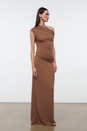 Women's draped one-shoulder maxi dress in warm brown, side view with gathered detail.