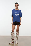 Tall suede patchwork boots on model, cream with red and brown heart motifs and low heel