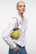 Yellow feather-fringe mini shoulder bag with dark beaded trim and leather top handle.