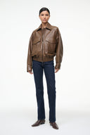 Brown leather bomber jacket with stand collar, zip front, and chest flap pockets