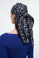 Silk scarf headwrap with navy multicolor circle print and large bow knot, draped