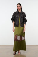 Olive green silk dress with spaghetti straps and brown-and-white lace hem, styled with jacket