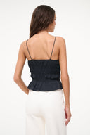 Black peplum cami top with thin straps, back view