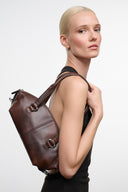 Mini shoulder bag in dark brown distressed leather with buckle strap and side straps