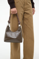 Truffle brown shoulder bag with braided cuff handles and silver knot detail