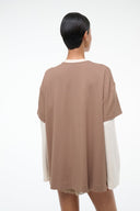 Taupe short-sleeve tee with lace-trim hem and white long-sleeve underlayer, back view
