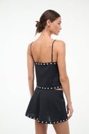 Black linen tank top with spaghetti straps and stud trim, back view