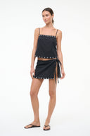 Black linen tank top with stud trim, spaghetti straps; tied side mini skirt, full length