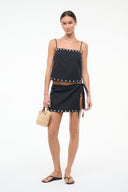 Black linen tank top with stud trim and spaghetti straps; tied mini skirt, full front