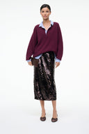 Espresso satin slingback ballet heels on model with burgundy top and sequined skirt