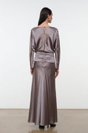 Back view of zinc satin silk dress with long sleeves, ruched waist, and full skirt
