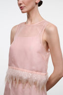 Pink sleeveless sheer top with round neckline and feather fringe hem band