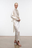 Ivory silk midi dress with high neckline, long sleeves, side tie, and front slit