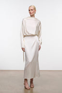 Ivory silk midi dress with draped high neck, long sleeves, and hanging waist tie