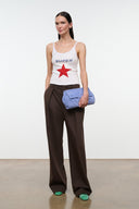 VATOLLA white tank top with 'SUPER' and red star; blue clutch held