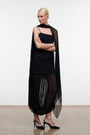 Black sleeveless shift dress with sheer cape drape and long tulle-like skirt