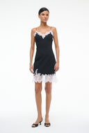 Black mini dress with white lace scallop trim at bust and hem, slim silhouette