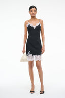 Black mini dress with white lace trim, spaghetti straps and scalloped short hem
