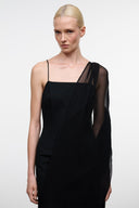 Black sleeveless dress with square neckline and sheer long overlay at shoulder