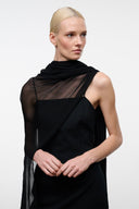 Black sleeveless dress with sheer sleeveless shawl overlay and layered neckline