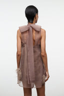 Taupe mini dress back with large bow at collar and feathered trim at hem